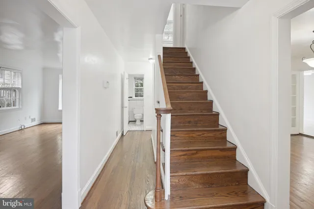a view of entryway and hall with wooden floor