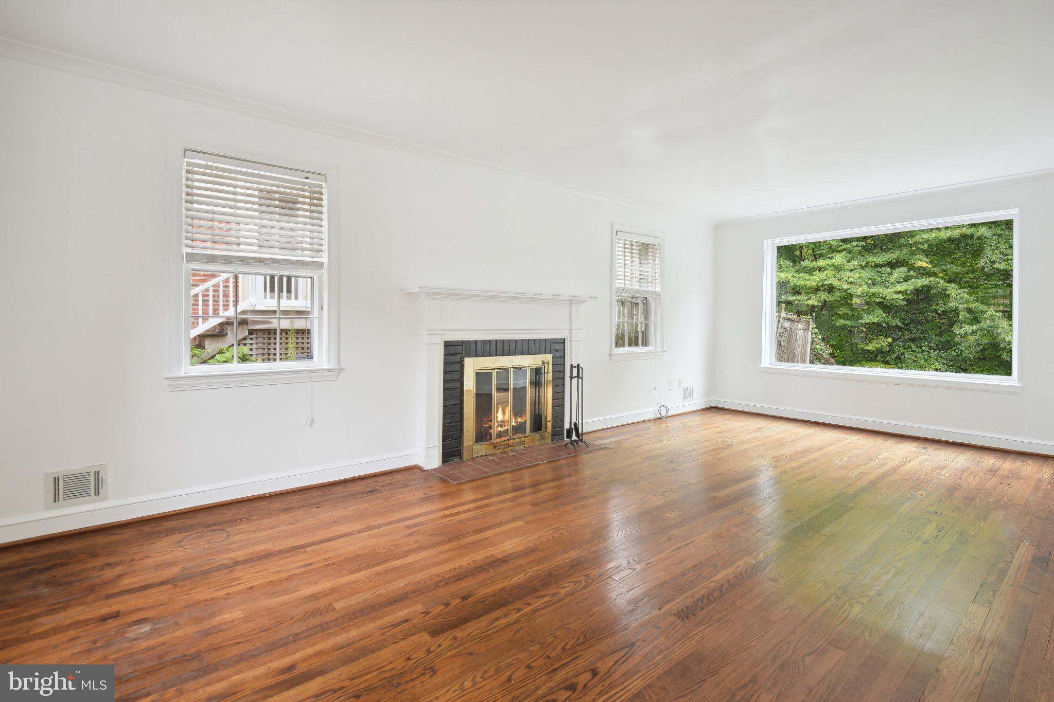 2926 Kanawha Street Northwest Washington, DC 20015 - Photo 5 of 34 a view of an empty room with wooden floor and a window