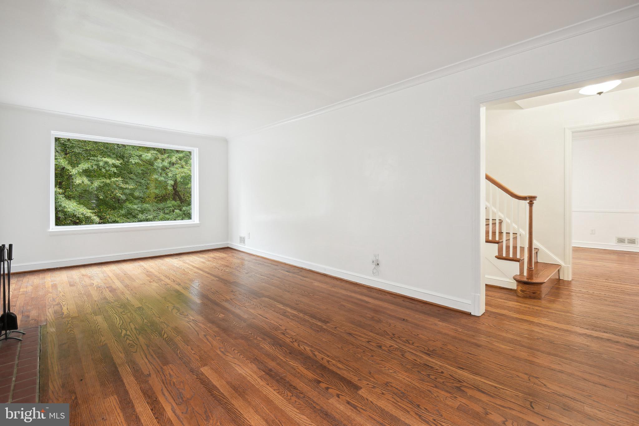 2926 Kanawha Street Northwest Washington, DC 20015 - Photo 8 of 34 a view of an empty room with wooden floor and a window
