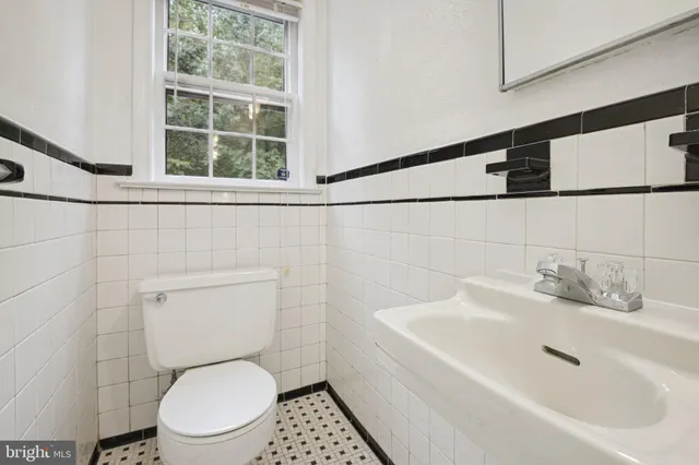 a bathroom with a toilet sink and mirror