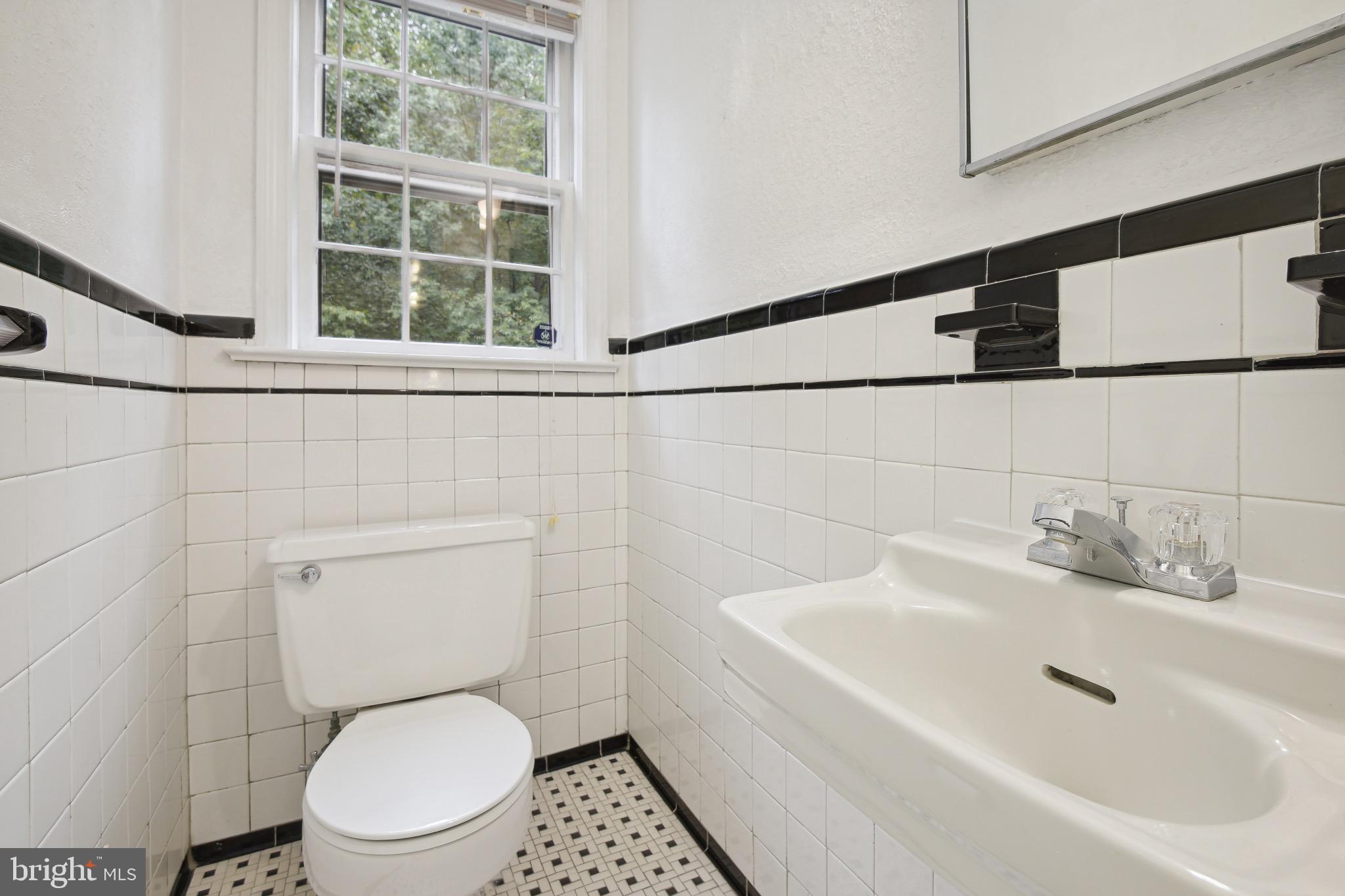 2926 Kanawha Street Northwest Washington, DC 20015 - Photo 9 of 34 a bathroom with a toilet sink and mirror
