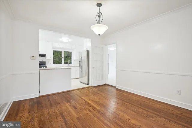 a view of a room with wooden floor and windows
