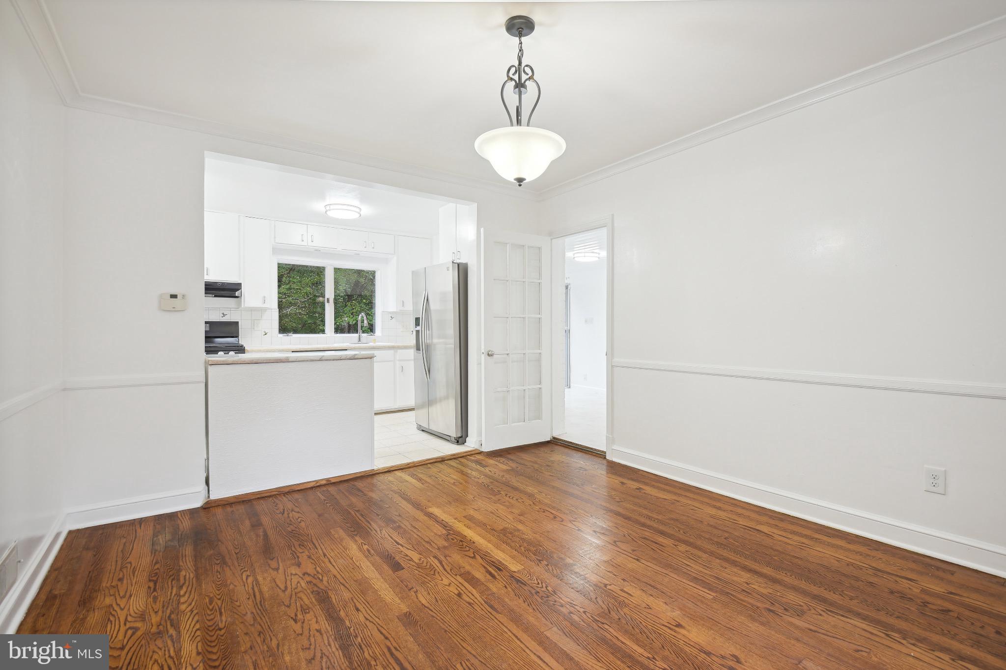 2926 Kanawha Street Northwest Washington, DC 20015 - Photo 10 of 34 a view of a room with wooden floor and windows