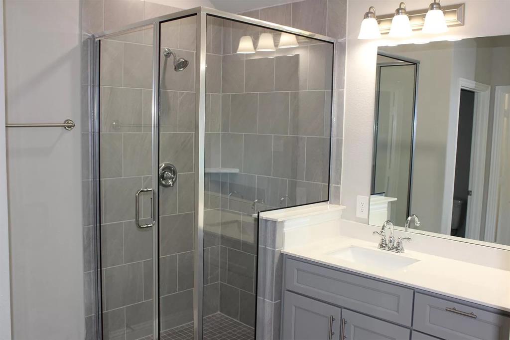 1752 Redding Street Allen, TX 75002 - Photo 13 of 24 Bathroom with vanity, a shower with door, and toilet