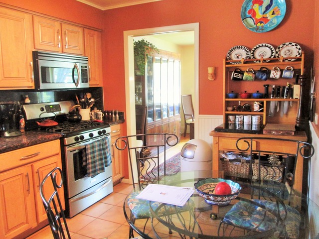 3655 Poplar Road Flossmoor, IL 60422 - Photo 22 of 23 a kitchen with stainless steel appliances granite countertop a stove a dining table and chairs with wooden floor