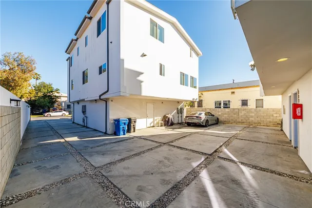 a view of a kitchen with a fridge and wooden floor