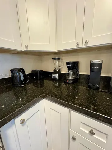 a bedroom with a bed and a flat tv screen on the dresser