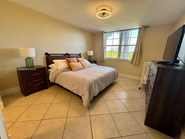 a bedroom with a bed and a television