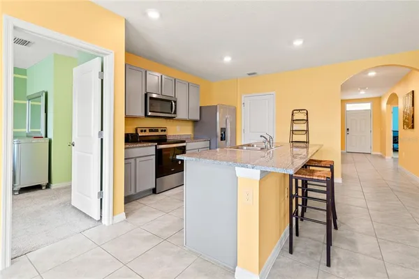 a kitchen with a sink cabinets and stainless steel appliances