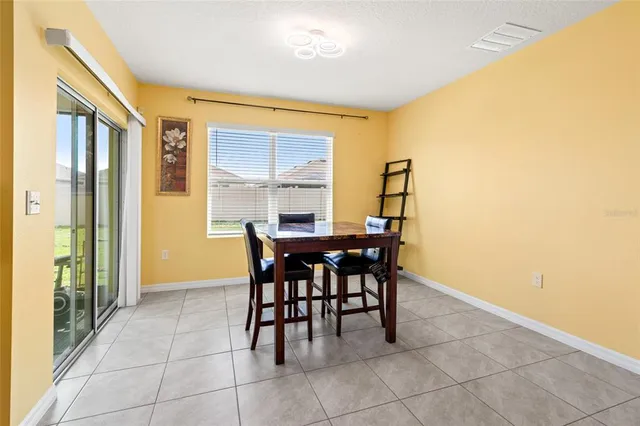a dining room with furniture and window