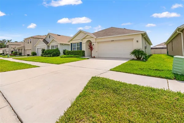 a front view of a house with a yard and garage