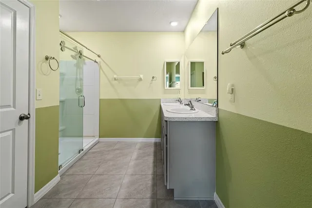 a bathroom with a sink a mirror and a shower