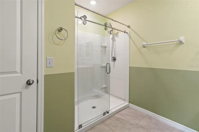a bathroom with a glass shower door