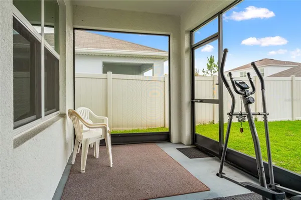 a balcony with chairs and a table