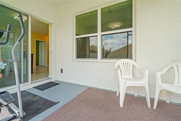a view of a room that has a window and chair