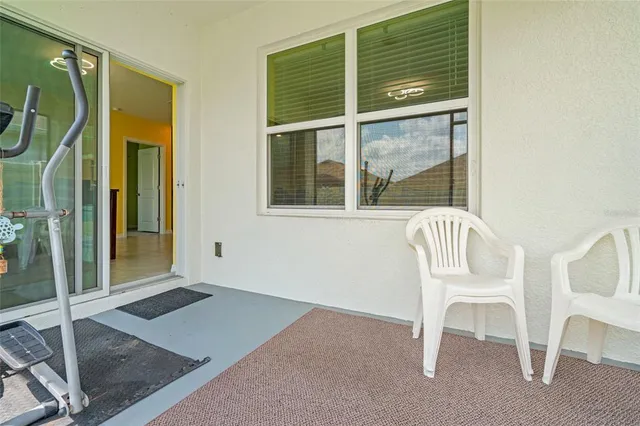 a view of a room that has a window and chair