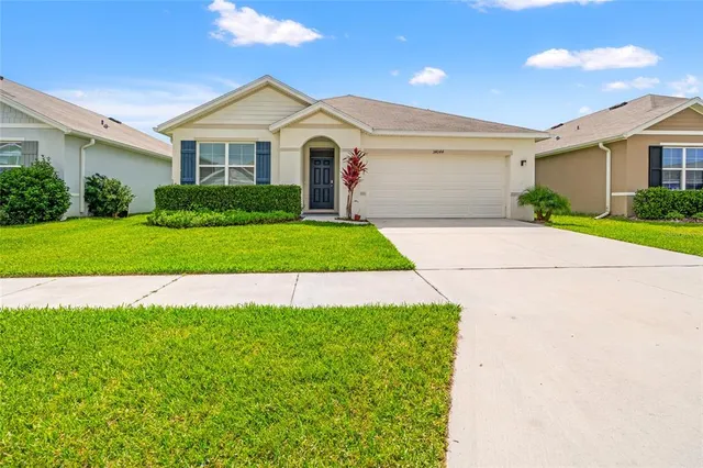 a front view of a house with a yard and garage
