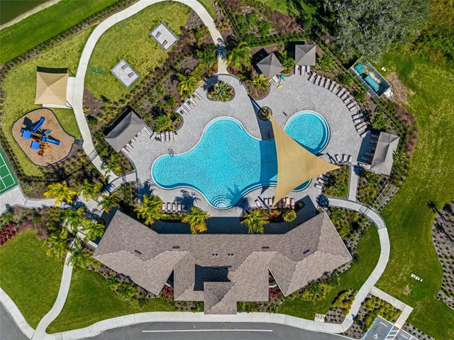 an aerial view of a house with a swimming pool