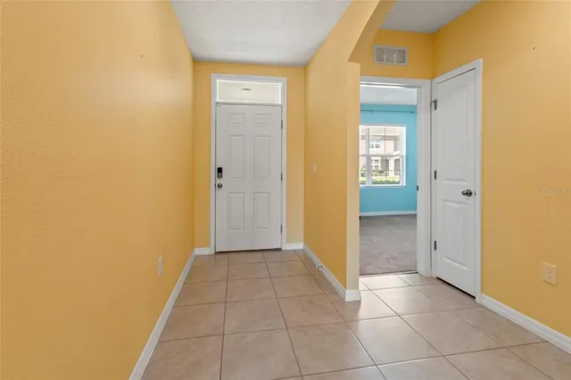 a view of a hallway with closet and a bathroom