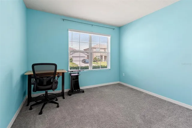 a view of workspace with furniture and a window
