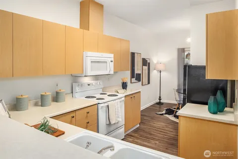 a kitchen with a sink cabinets and appliances