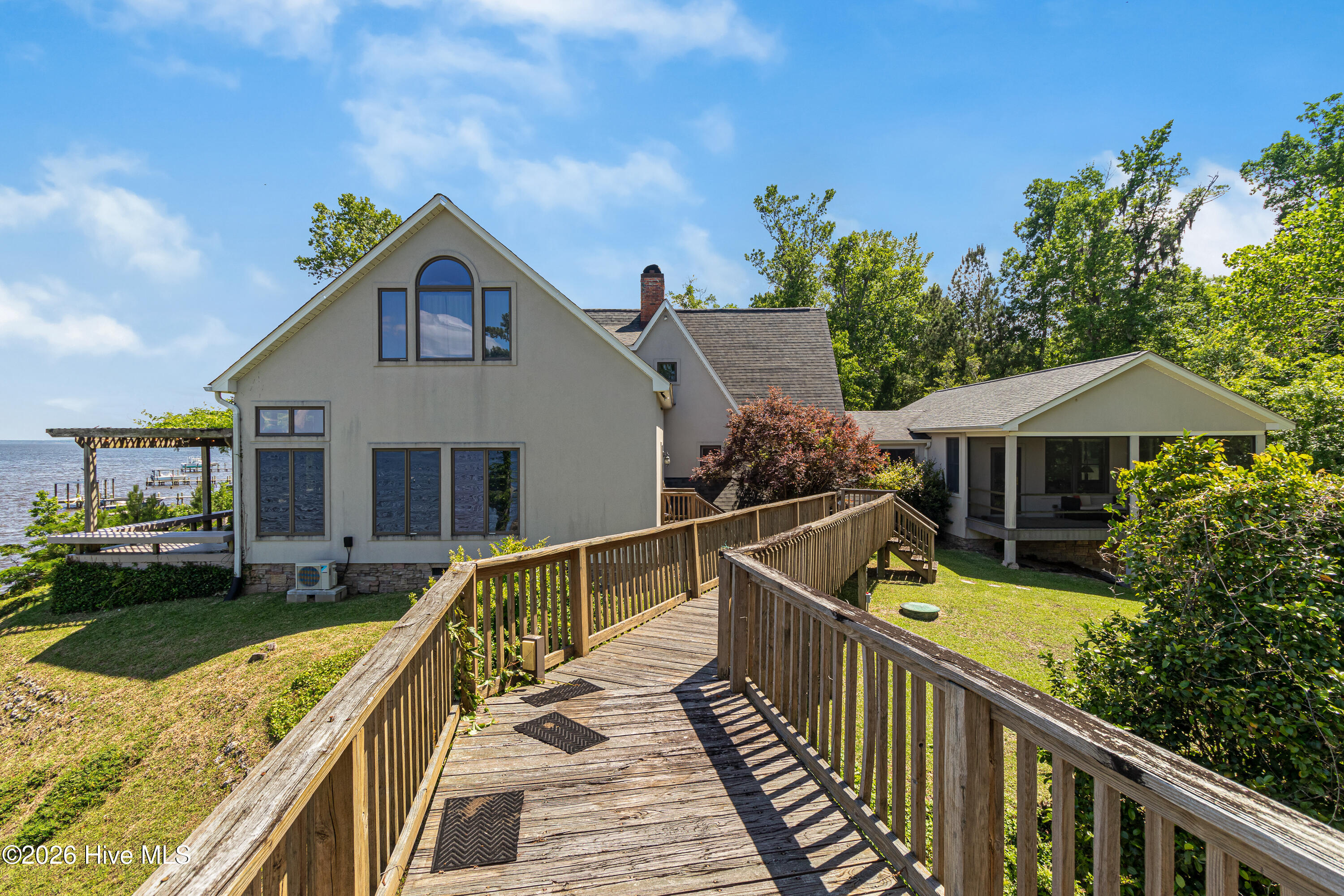 4100 North Rivershore Drive New Bern, NC 28560 - Photo 45 of 87 A distinctive elevated walkway connects the main residence to a private guest retreat, creating a one-of-a-kind waterfront compound feel with panoramic lake views from nearly every angle.