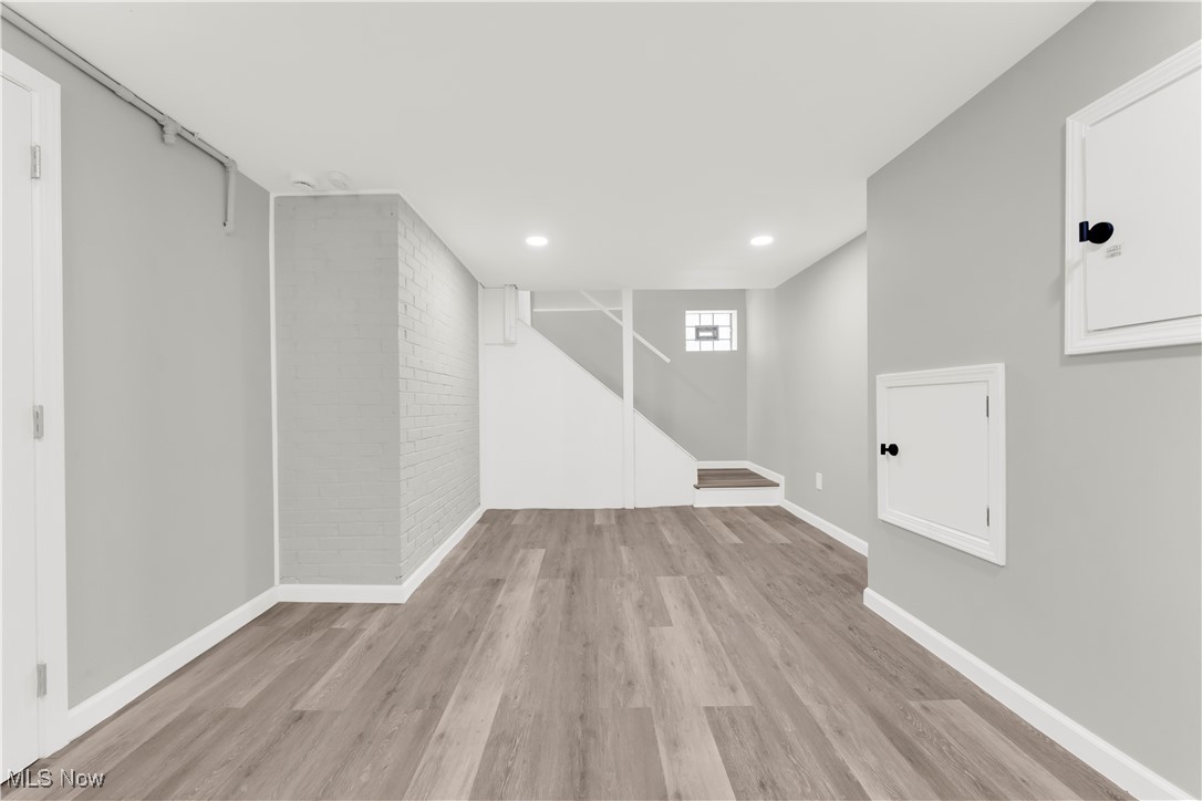 3964 Navahoe Road Cleveland Heights, OH 44121 - Photo 26 of 30 Basement with baseboards, wood finished floors, recessed lighting, stairway, and brick wall
