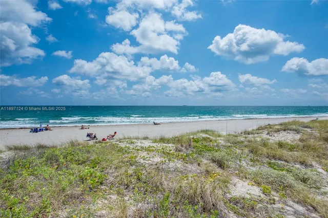 a view of a lake with houses in the back