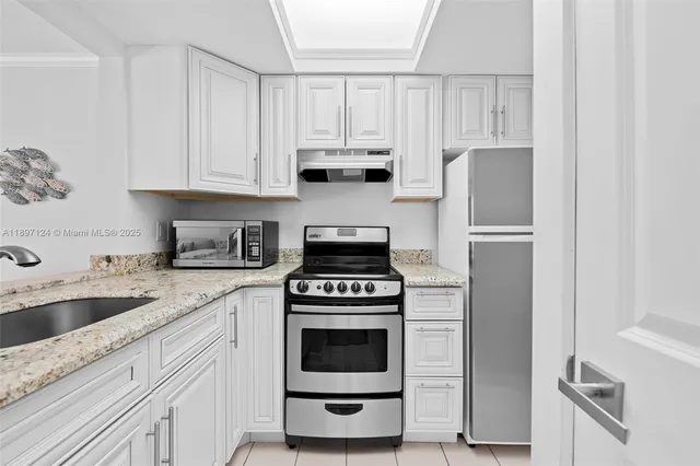 a kitchen with cabinets appliances and a sink