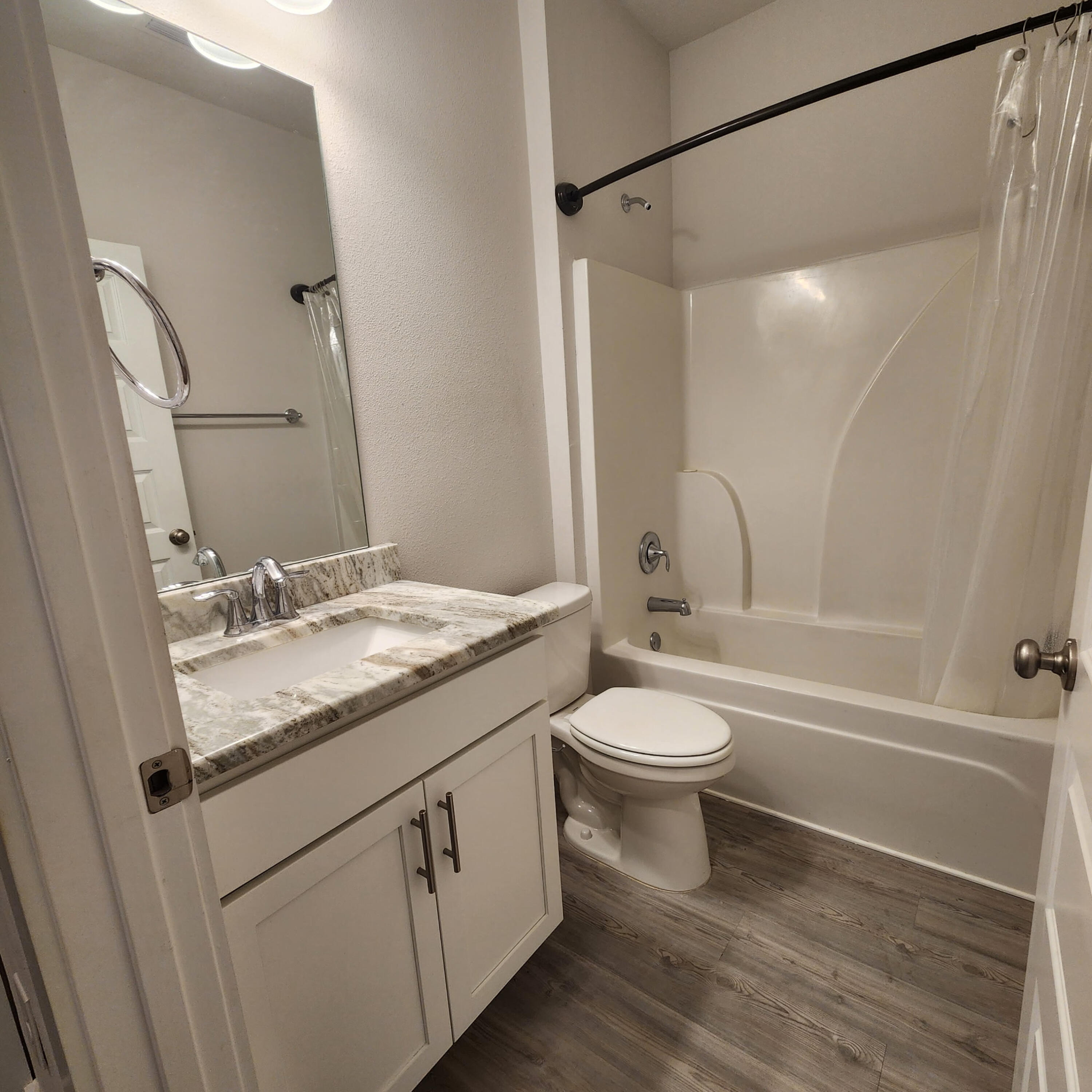 1927 Appleton Drive Cantonment, FL 32533 - Photo 4 of 8 a bathroom with a granite countertop sink toilet a mirror and shower