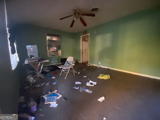 a living room with hard wood flooring and a couch