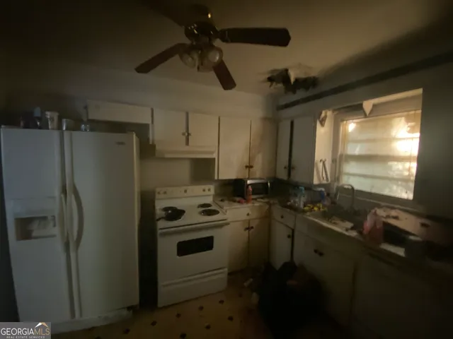 a kitchen with a sink appliances and cabinets