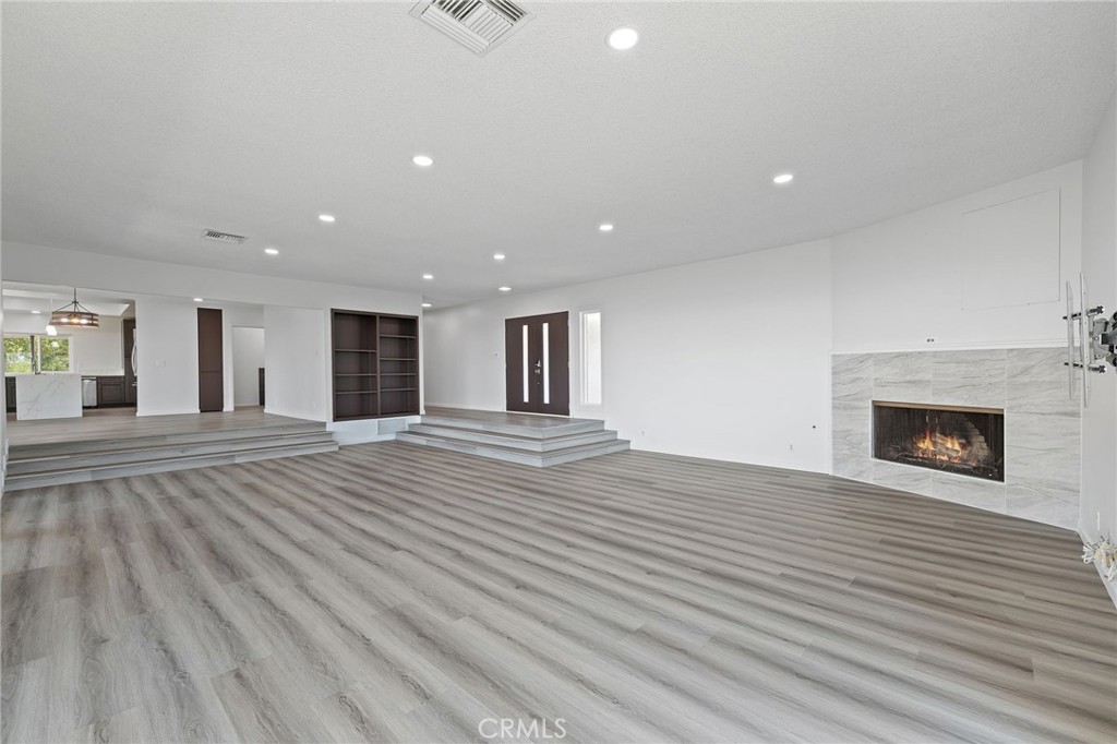 1281 Mayapan Road La Habra Heights, CA 90631 - Photo 11 of 65 a view of a livingroom with wooden floor and a fireplace