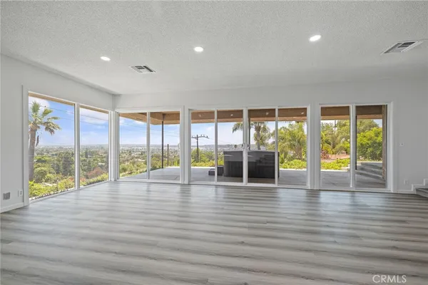 a view of a living room and kitchen with a wooden floor