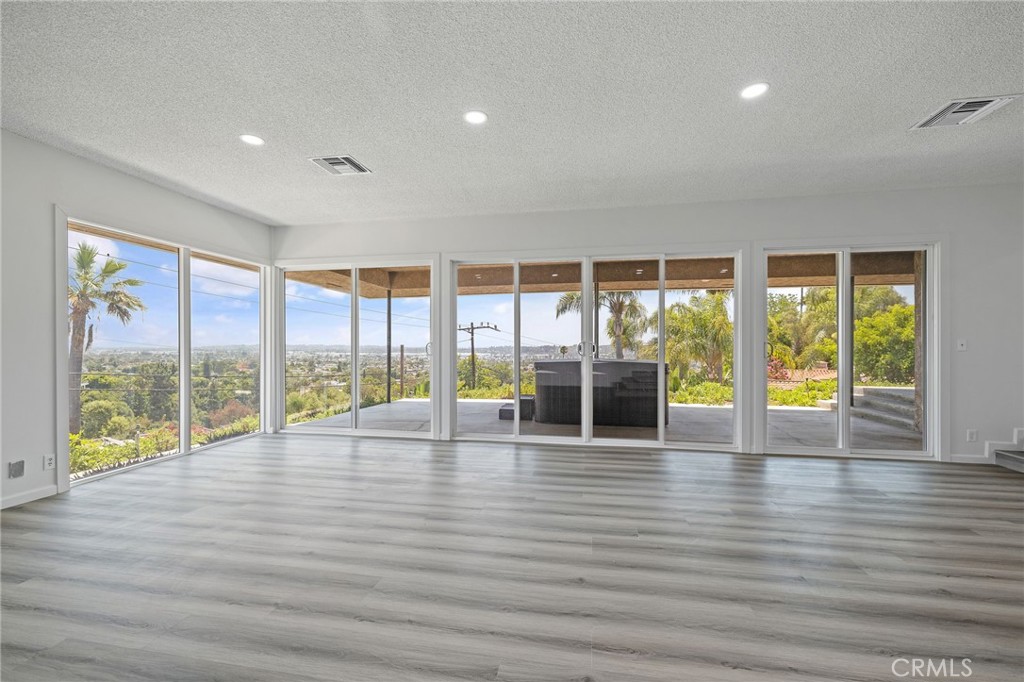 1281 Mayapan Road La Habra Heights, CA 90631 - Photo 13 of 65 a view of an empty room with wooden floor and floor to ceiling window