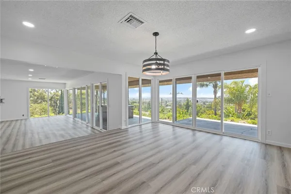 a kitchen with a refrigerator a sink and wooden floor