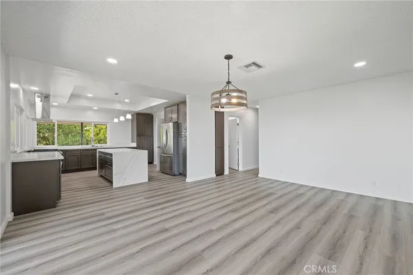 a kitchen with a stove a sink and a refrigerator