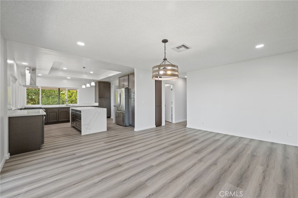 1281 Mayapan Road La Habra Heights, CA 90631 - Photo 17 of 65 a view of a living room and kitchen with a wooden floor