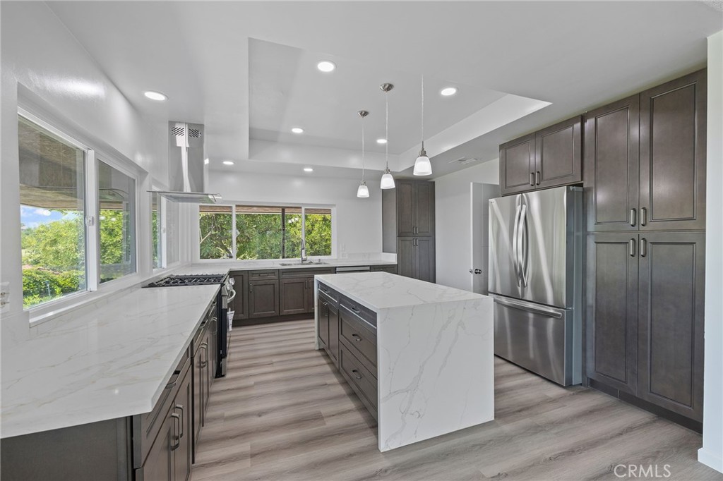 1281 Mayapan Road La Habra Heights, CA 90631 - Photo 19 of 65 a kitchen with a refrigerator a sink and wooden floor