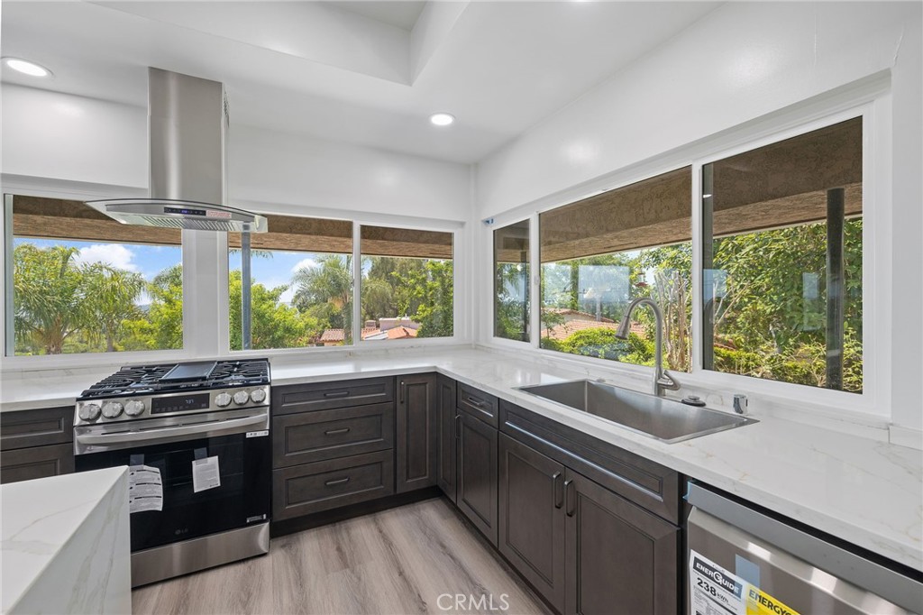 1281 Mayapan Road La Habra Heights, CA 90631 - Photo 23 of 65 a kitchen with stainless steel appliances granite countertop a sink a stove a counter space and cabinets
