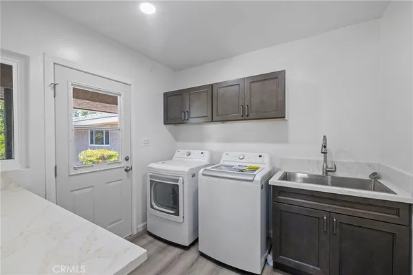 a view of an empty room with wooden floor and closet
