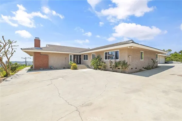 a view of house with yard and car parked in front of it