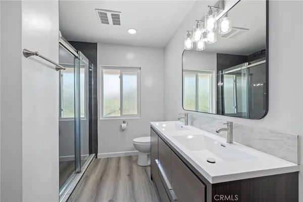 a aerial view of a house with a big yard and large tree