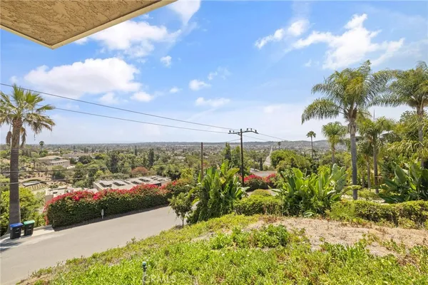 an aerial view of a house with a yard basket ball court and outdoor seating