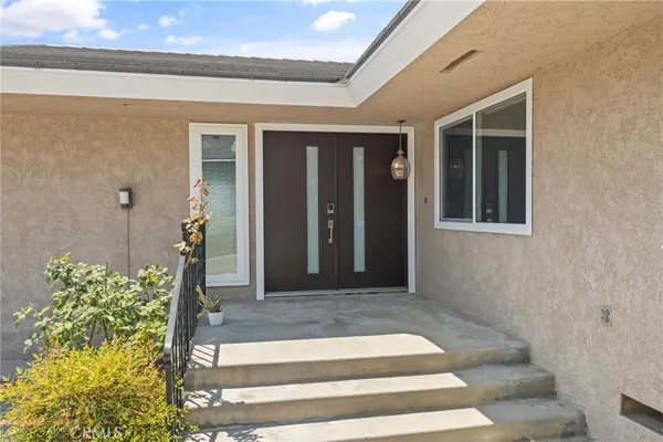 an empty room with wooden floor and floor to ceiling window