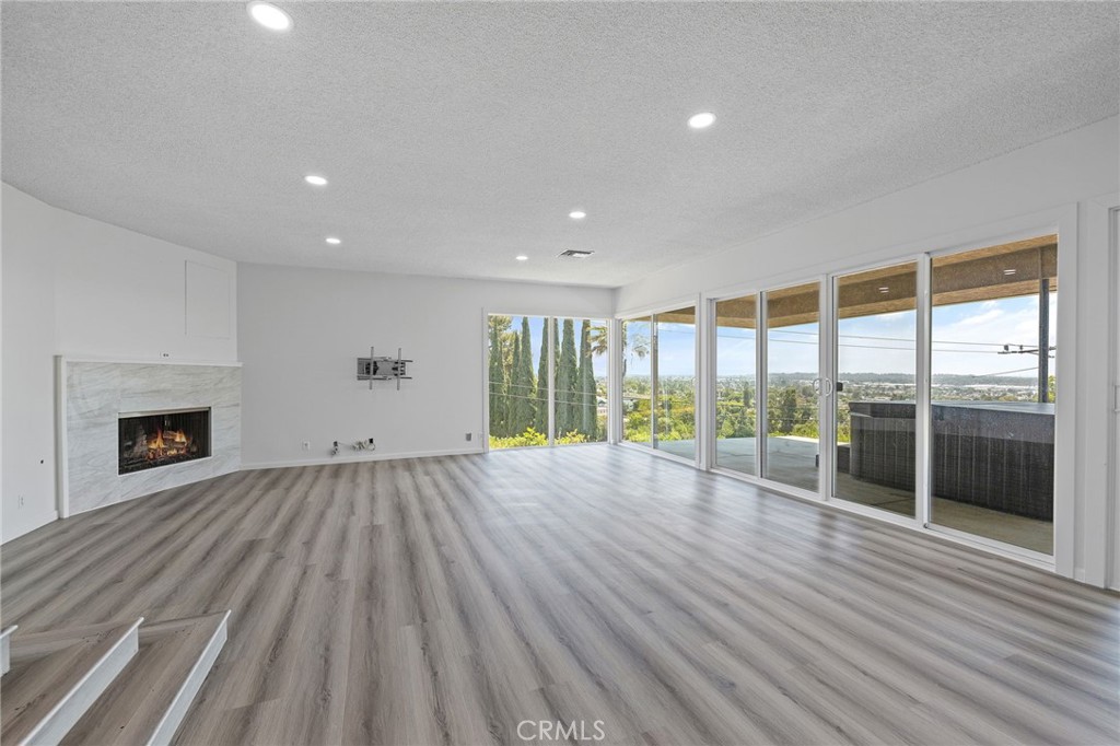 1281 Mayapan Road La Habra Heights, CA 90631 - Photo 9 of 65 a view of empty room with wooden floor and fireplace