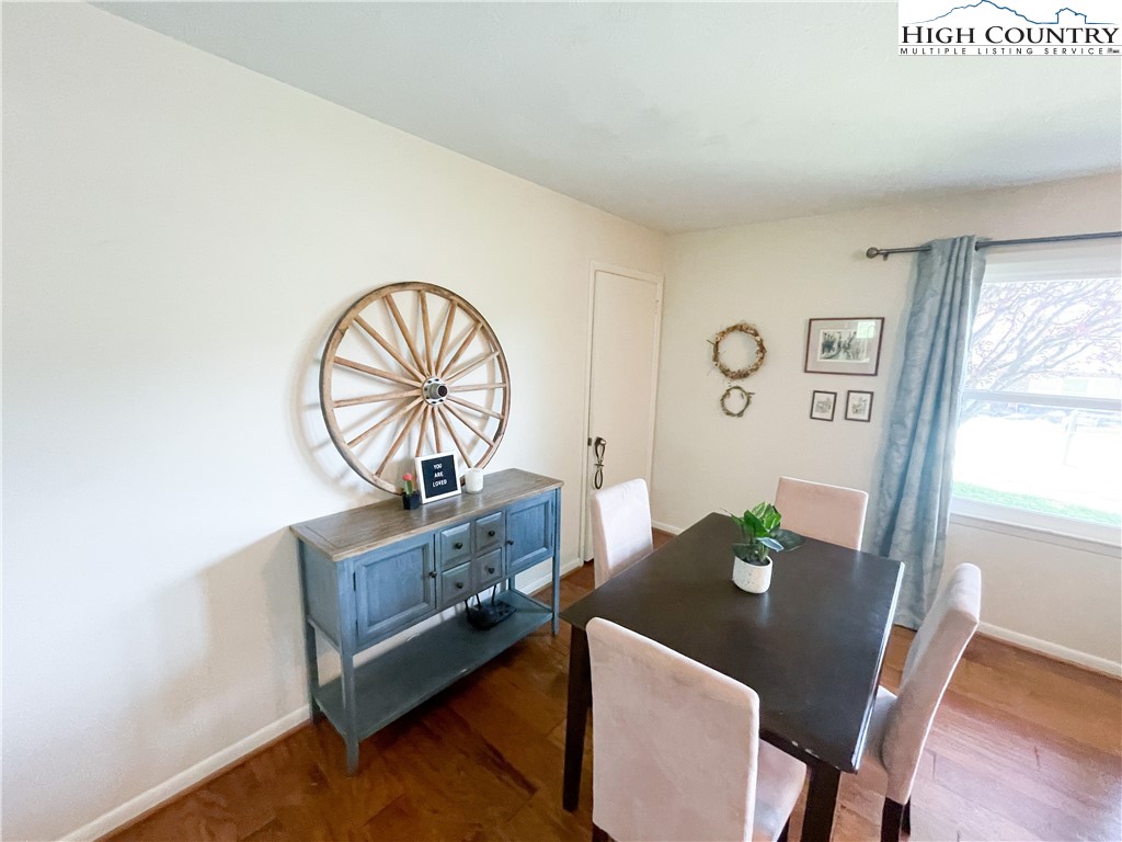 153 Wey Street Boone, NC 28607 - Photo 14 of 41 a view of a dining room with furniture a potted plant and wooden floor