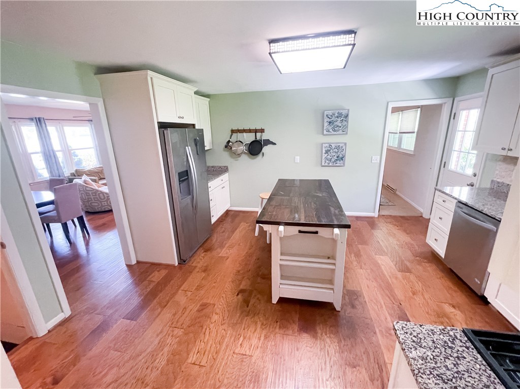153 Wey Street Boone, NC 28607 - Photo 16 of 41 a room with wooden floors and a fireplace