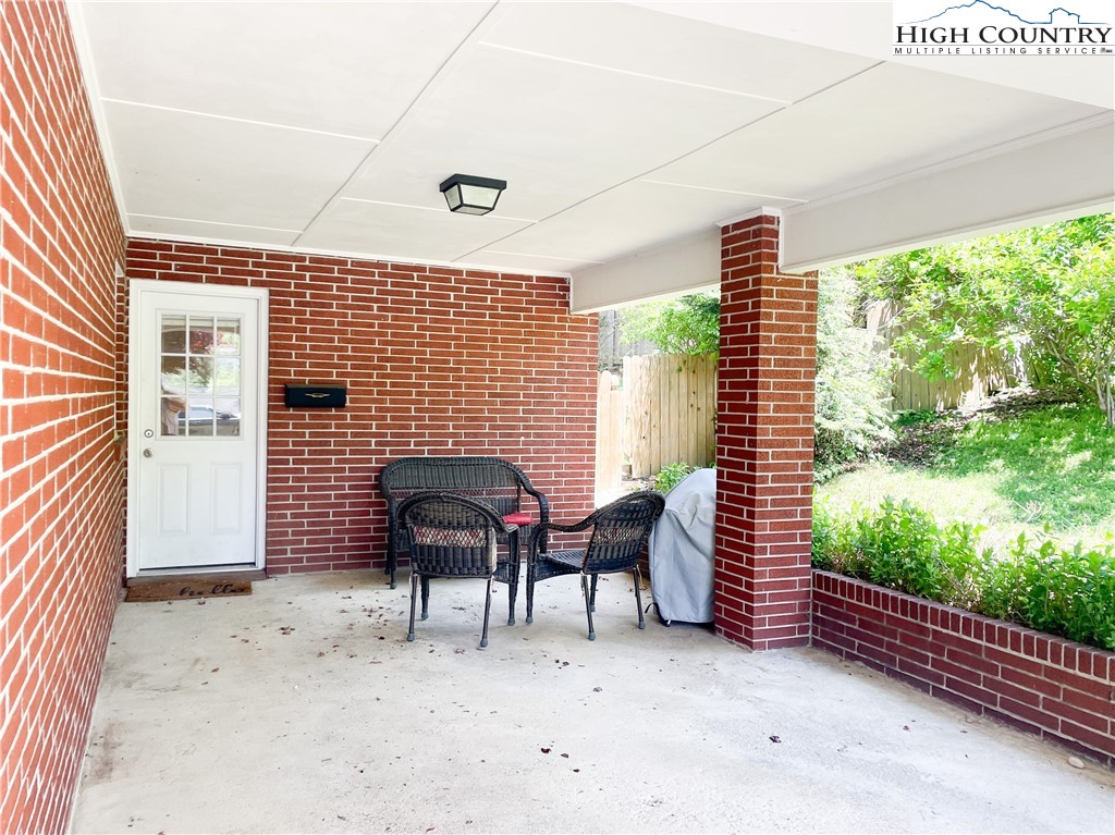 153 Wey Street Boone, NC 28607 - Photo 9 of 41 a view of a patio with table and chairs and wooden fence