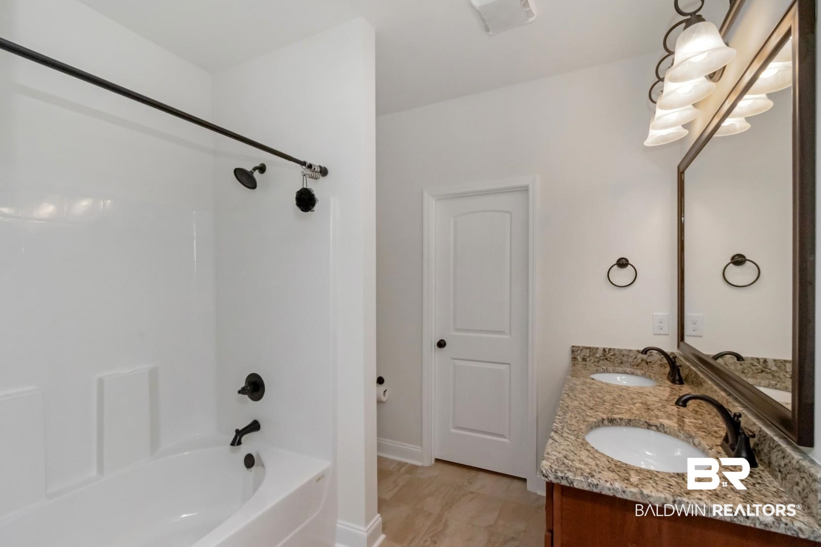 10714 Brodick Loop Spanish Fort, AL 36527 - Photo 16 of 26 Full bath with bathing tub / shower combination, double vanity, and marble finish flooring